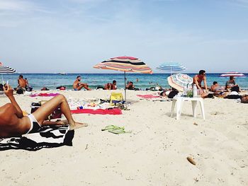 People relaxing on beach