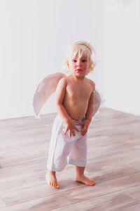 Full length of shirtless boy at home