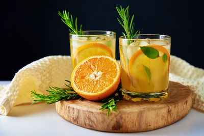 Orange fresh lemonade in glass on dark background