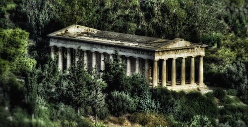 Built structure by trees against sky