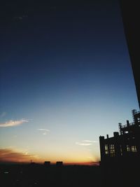 Low angle view of built structure against sky at sunset