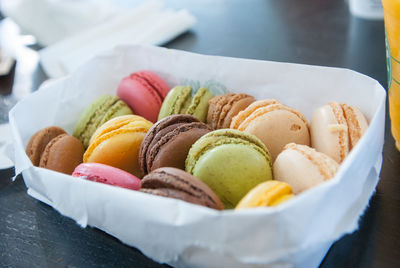 Close-up of various colours macaroons in a paper plate