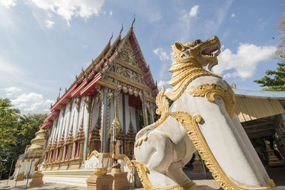 Low angle view of statue against temple building