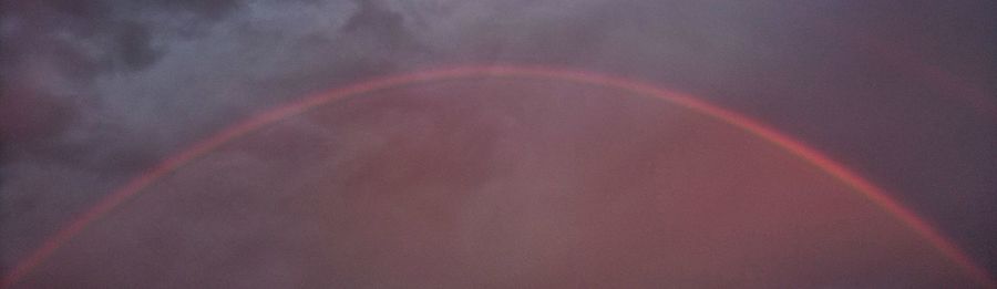 Low angle view of rainbow against sky
