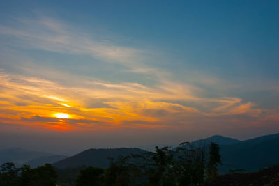 Scenic view of silhouette mountains against sky at sunset