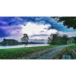 Scenic view of field against cloudy sky