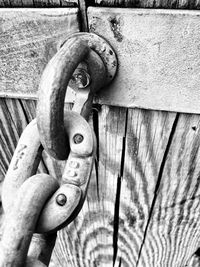 Close-up of rusty chain on wooden door