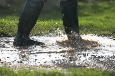 Low section of person splashing water