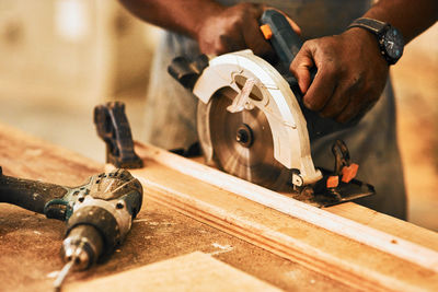 Cropped hands of carpenter working at workshop