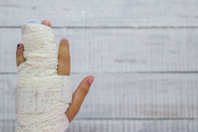 Close-up of woman hand on wood