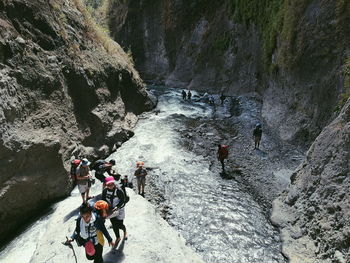 High angle view of people on rocks by water