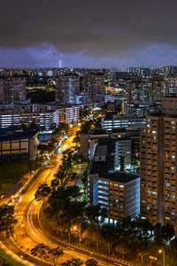 High angle view of illuminated city buildings at night