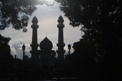 Silhouette of temple building against sky