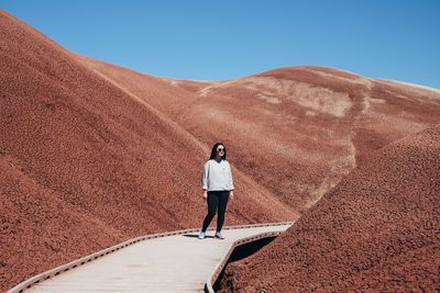 Full length of woman standing on mountain