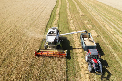 Aerial view of combine harvester working in field