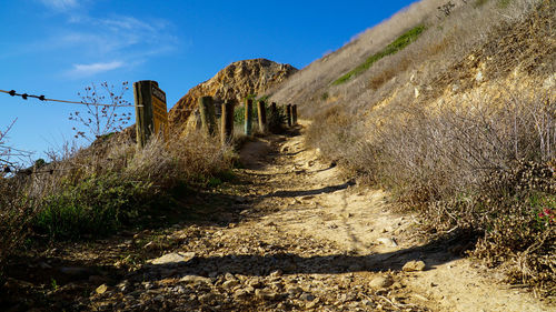 Footpath on field against sky