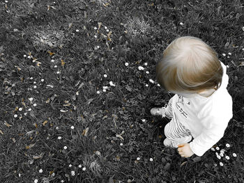 High angle view of baby girl in grass