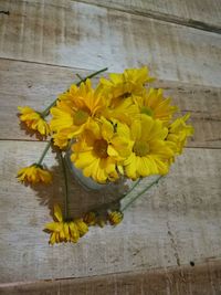 Yellow flowers in vase on table