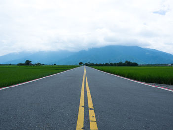 Road amidst landscape against sky