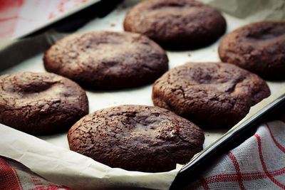 Close-up of chocolate cookies in baking sheet on table