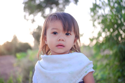 Portrait of girl standing on land during sunset