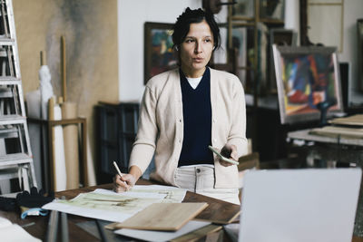 Portrait of young woman reading book