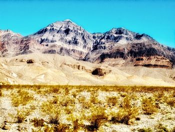 Scenic view of mountains against clear blue sky