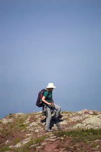 Woman on mountain against sky