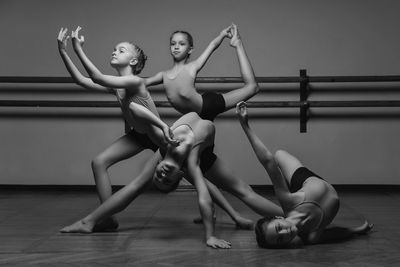 Black and white image of a group of modern little ballerinas standing in a modern dance pose. 