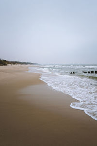 Scenic view of beach against clear sky