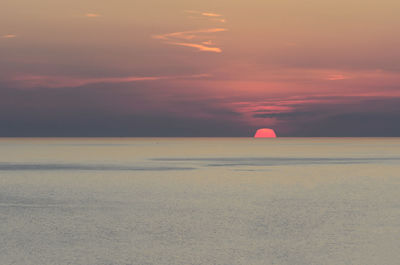 Scenic view of sea against romantic sky at sunset