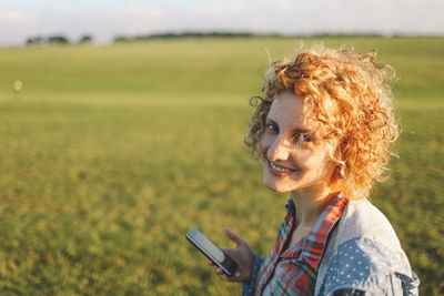 Young serene woman looking at camera in the countryside