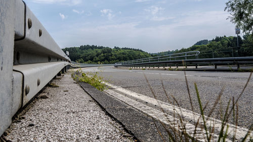 Road by bridge against sky