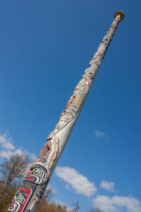 Low angle view of cross against blue sky