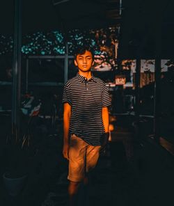 Portrait of smiling man standing at night