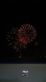 Low angle view of firework display at night