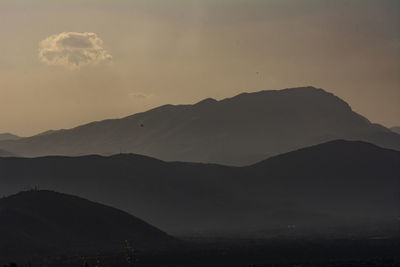 Scenic view of silhouette mountains against sky at sunset