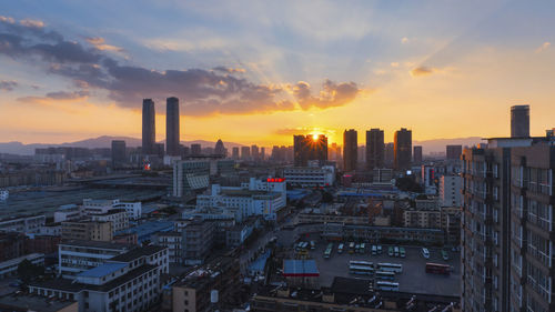 View of cityscape against cloudy sky