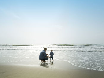 Father and son on a beach day, bajondillo beach in torremolinos,