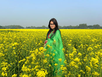 Scenic view of oilseed rape field against sky