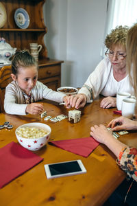 Happy friends sitting on table