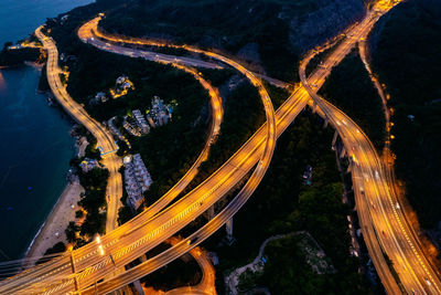 Aerial view of illuminated highway in evening