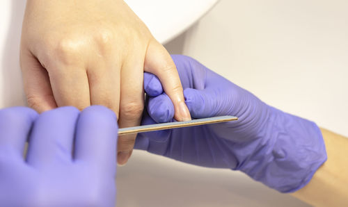 Cropped hand of person holding felt tip pens