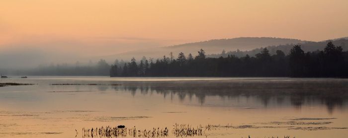 Scenic view of lake against sky during sunset