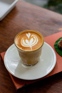 Coffee latte art on table in coffee shop.