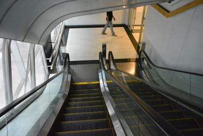 High angle view of people walking on escalator