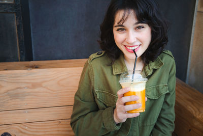 Portrait of smiling man holding drink