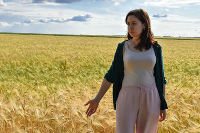 Young woman standing on field