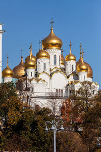 Church by building against clear sky