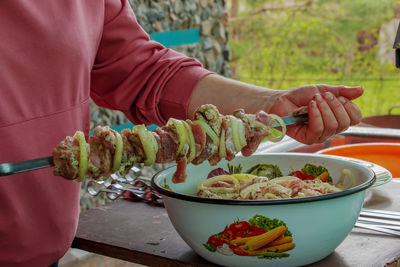 Midsection of man preparing food